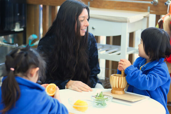 Ficino-Montessori-Preschool-Gallery 1 A student talking to their teacher at Ficino Montessori Private PreSchool in Auckland