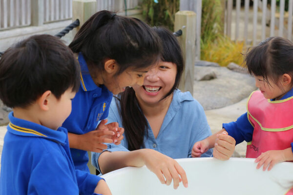 Ficino-Montessori-Preschool-Gallery 2 Children and a teacher playing and interacting at Ficino Montessori Private PreSchool in Auckland