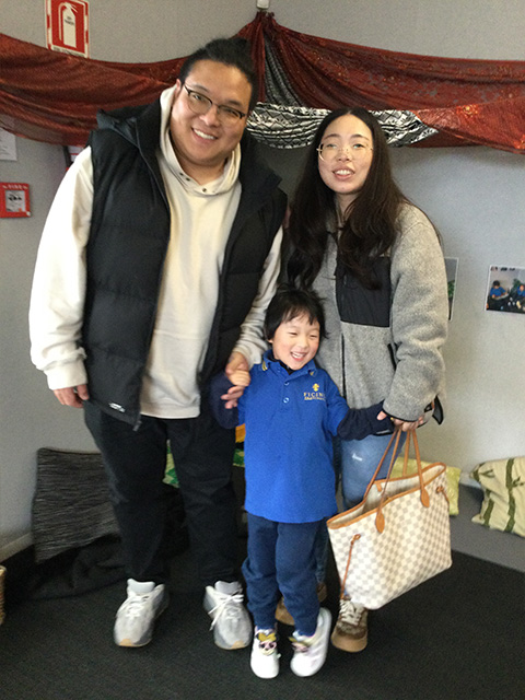 Mum and Dad with their child at Ficino Montessori Private PreSchool in Auckland.
