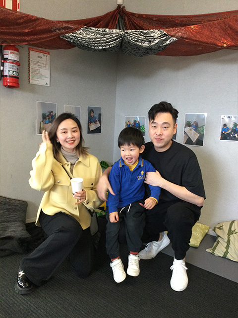 Parents with their child sitting for a photo at Ficino Montessori Private PreSchool in Auckland.
