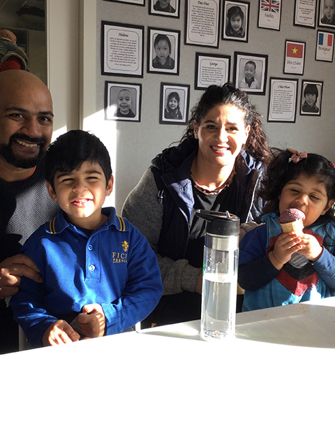 Two parents and two children sitting at a desk at a private Montessori preschool in Mt Eden, Auckland.